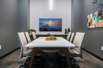 a dining room with a white table and white chairs at Marquee, Minnesota